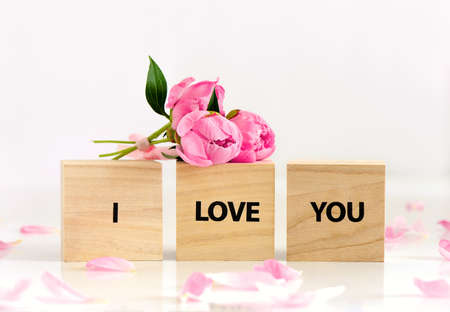 Romantic greeting card concept with ''I love You'' text and peonies bouquet, front viewの写真素材