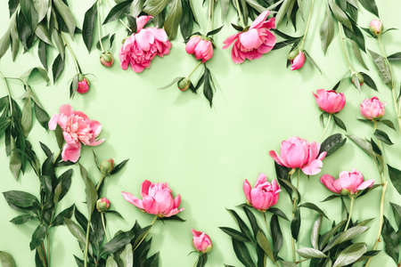 Spring and romance concept, flat lay of peonies in a heart shape space, overhead view, space for a textの写真素材
