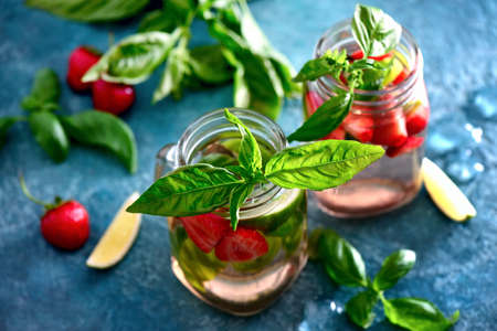 Strawberry and basil limeade in two glass jars, view from above