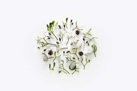 Christmas greeting card template with mistletoe small branches and cones decorative composition, flat lay, space for a textの写真素材