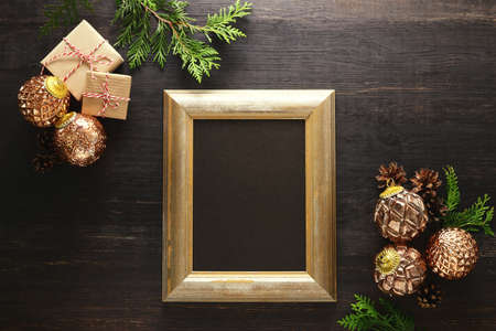 Christmas or New Year background with blank space for a text in a golden vintage frame, flat lay...