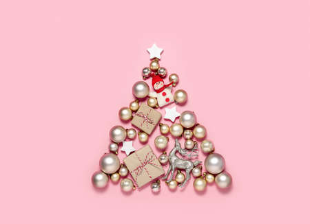 Christmas tree concept, flat lay of Christmas tree decorations lying down on pastel pink backgroundの写真素材