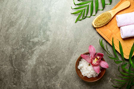 Spa background with sea salt and massage brush, view from above, space for a textの写真素材