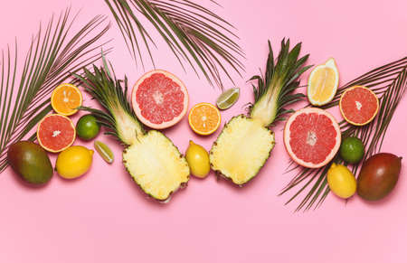 Various tropical fruits composition with palm leaves decoration, flat lay summer backgroundの写真素材