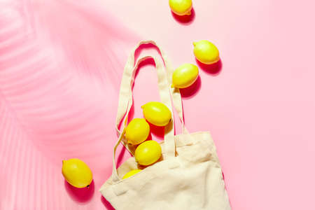 Summer concept with scattered out of shopping bag lemons, view from aboveの写真素材