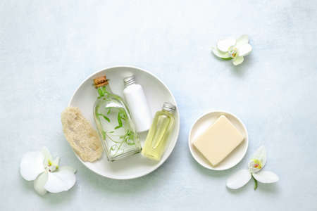 Spa and bath natural cosmetic products such as healing herbal infusion or skin lotion, essential oil and soap, view from aboveの写真素材