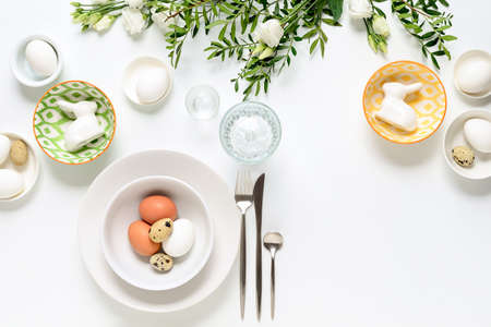 Easter dinner table setting, home holiday decor concept, view from above, blank space for a textの写真素材