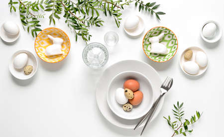 Easter dinner table setting, home holiday decor concept, view from above, blank space for a textの写真素材