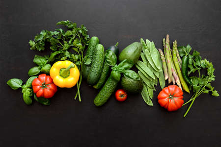 Dark flat lay culinary background with fresh produce, view from above, empty space for a textの写真素材