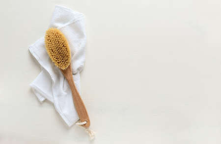 Wooden brush for dry brushing anticellulite massage, spa concept, flat lay beauty background with copy spaceの写真素材