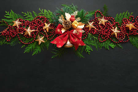 Noel or Christmas greeting card template with copy space for greetings or advertising text, view from above on traditional X-mas decorations lying down moody dark surfaceの写真素材