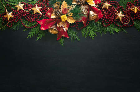 Noel or Christmas greeting card template with copy space for greetings or advertising text, view from above on traditional X-mas decorations lying down moody dark surfaceの写真素材