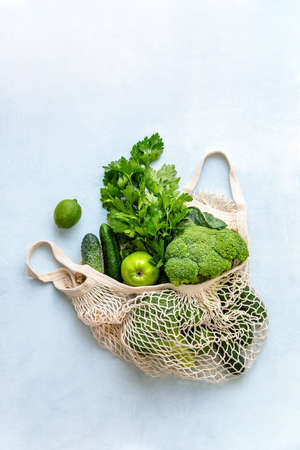 View from above on eco friendly bag filled with green organic vegetables, zero waste informed consumption conceptの写真素材