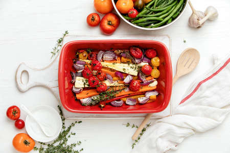 Autumn root vegetables such as carrots and parsnips roasted with paprika, red onion and tomatoes,...