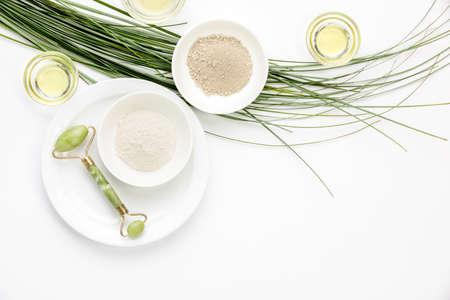 Spa treatment concept with clay, jade roller and natural oils, top down view, blank space for a textの写真素材