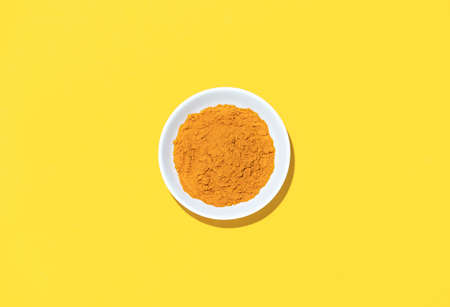 Turmeric powder in a bowl, view from above