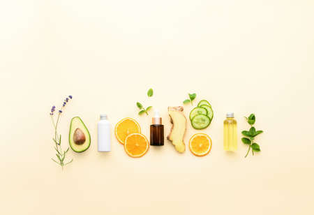 Natural cosmetics background with blank space for a text, fresh healing herbs and other natural ingredients for alternative cosmetic skin treatment such as ginger, cucumber or avocado, flat lay settingの写真素材