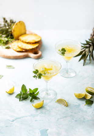 Pineapple coriander infused margarita in glasses with ingredients, front viewの写真素材
