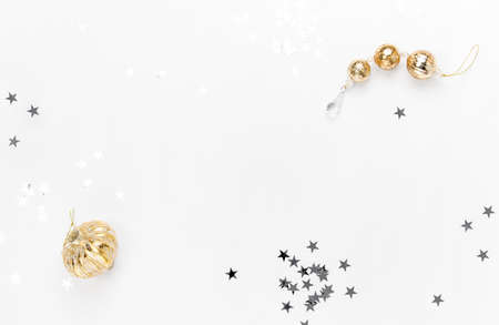 Noel or Christmas white  background with blank space for a greeting text, flat lay composition with star shaped glitter and golden colored Christmas decorationsの写真素材