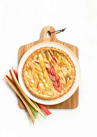Rhubab open faced round pie served on a wooden cutting board, overhead view, seasonal culinary conceptの写真素材