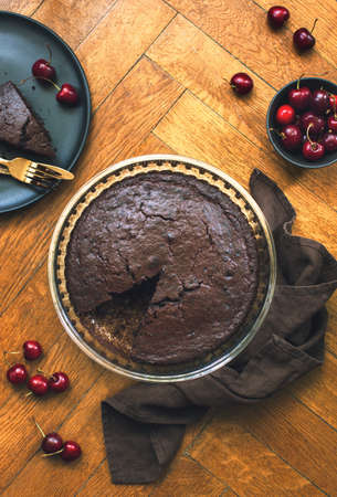 Home baked dark chocolate pie with cweet cherries, overhead viewの写真素材