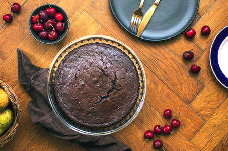 Home baked dark chocolate pie with cweet cherries, overhead viewの写真素材