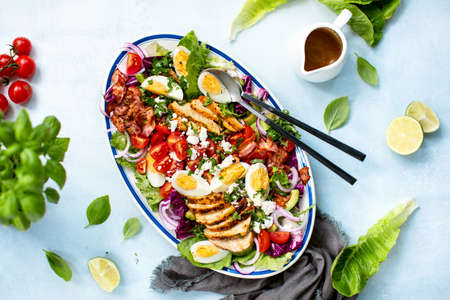 Homemade Cobb salad served in an oval dish, overhead viewの写真素材