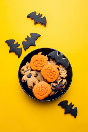 Homemade Halloween decorated cookies background, flat lay composition, ready to eat kids party treatsの写真素材