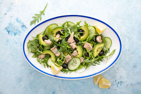 Tuna arugula salad served in an oval dish, top down view of the mealの写真素材