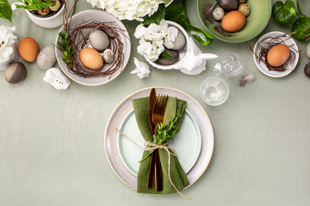 Easter table setting with traditional Easter home decor and tableware, overhead view
