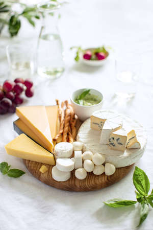 Cheese Board served with a chilled drink for a light snack, front viewの写真素材