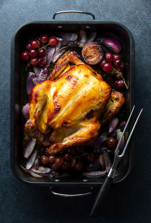 Fried chicken or turkey in a dark baking tray ready to eat, top-down viewの写真素材