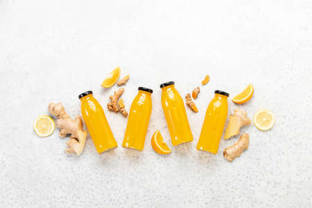 Ginger turmeric shots, healthy healing drink concept, flat lay composition with ingredientsの写真素材