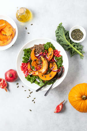 Roasted squash and kale quinoa salad in a white bowl, overhead viewの写真素材