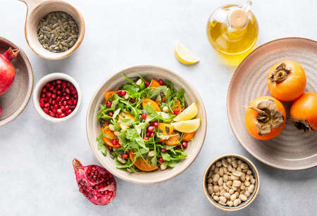 Arugula persimmon salad with ingredients, top-down viewの写真素材
