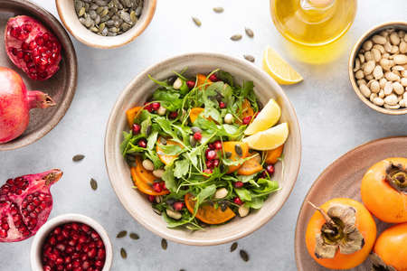 Arugula persimmon salad with ingredients, top-down viewの写真素材