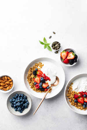 Homemade oatmeal or granola served with greek yogurt and  fresh berries, view from above, space for a textの写真素材