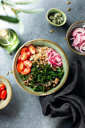 Kale and buckwheat vegan bowl with sauteed mushrooms and marinated red onion, top down viewの写真素材