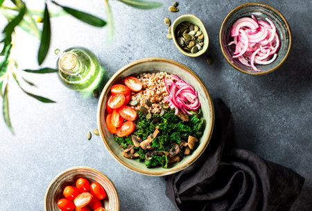 Kale and buckwheat vegan bowl with sauteed mushrooms and marinated red onion, top down viewの写真素材