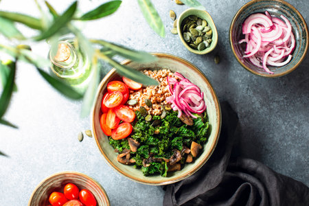 Kale and buckwheat vegan bowl with sauteed mushrooms and marinated red onion, top down viewの写真素材