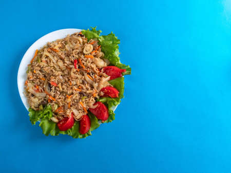 brown rice with vegetables on a blue backgroundの写真素材
