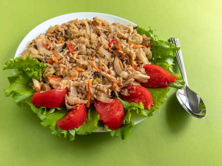 brown rice with vegetables on a green backgroundの写真素材