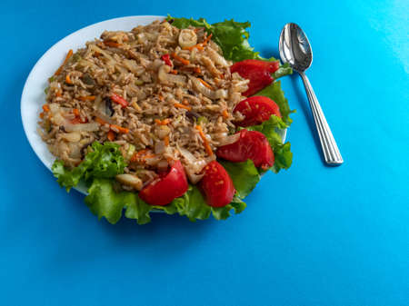 brown rice with vegetables on a blue backgroundの写真素材