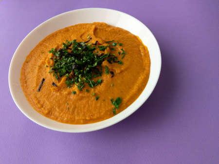 pumpkin cream soup in a white plateの写真素材