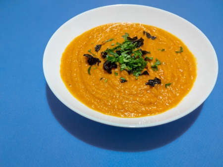 pumpkin cream soup in a white plateの写真素材