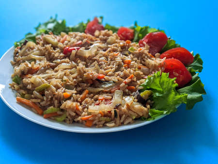 brown rice with vegetables on a blue backgroundの写真素材
