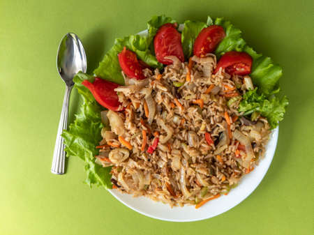 brown rice with vegetables on a green backgroundの写真素材