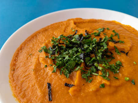 pumpkin cream soup in a white plateの写真素材
