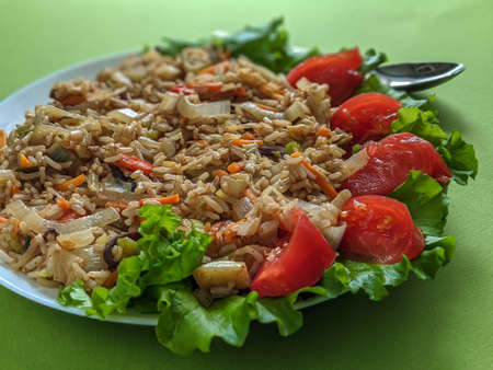 brown rice with vegetables on a green backgroundの写真素材