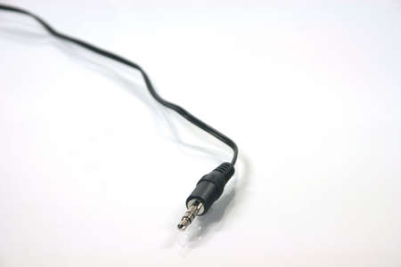 headphones plug with black cable in white backgroundの写真素材